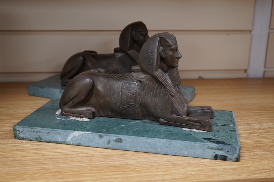 A pair of bronze models of Sphinxes, raised on green serpentine marble bases, 32cm long. Condition - fair, both detached from bases